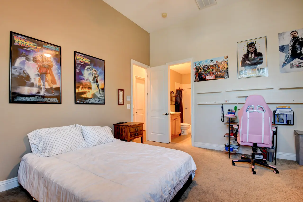 Bedroom with a desk area and a door to the hall