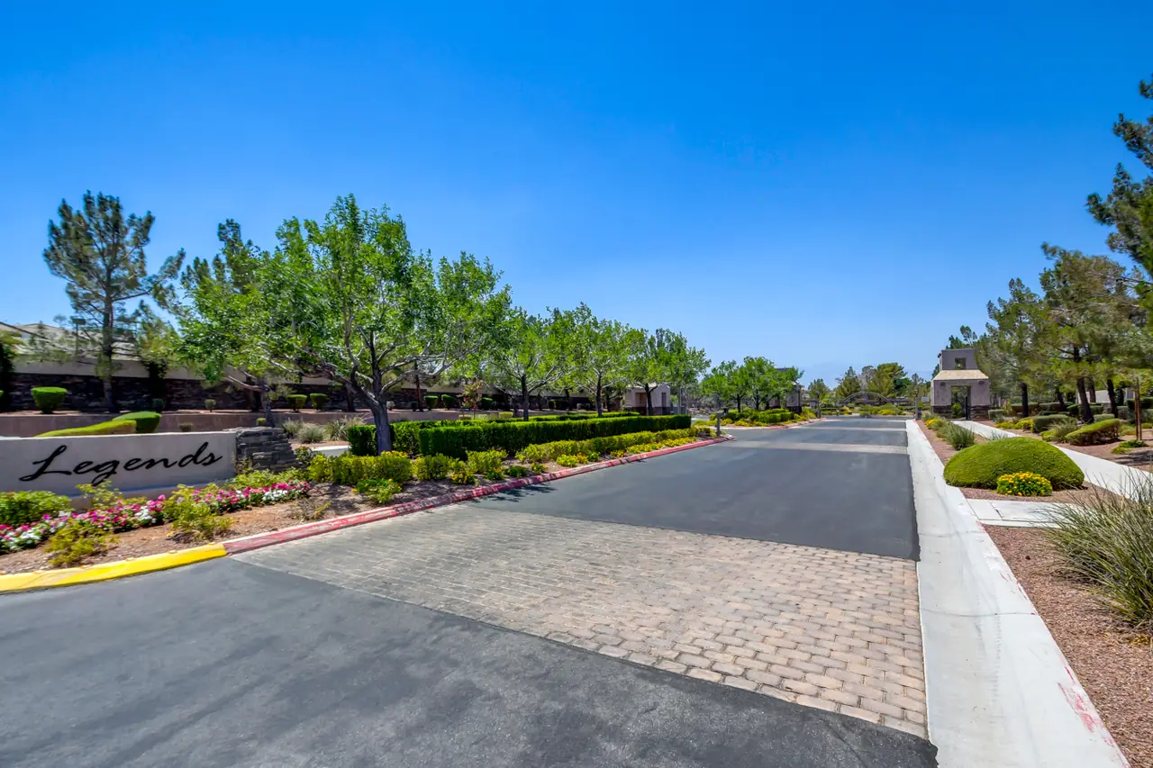 Legends entrance with a paver drive and landscaped medians