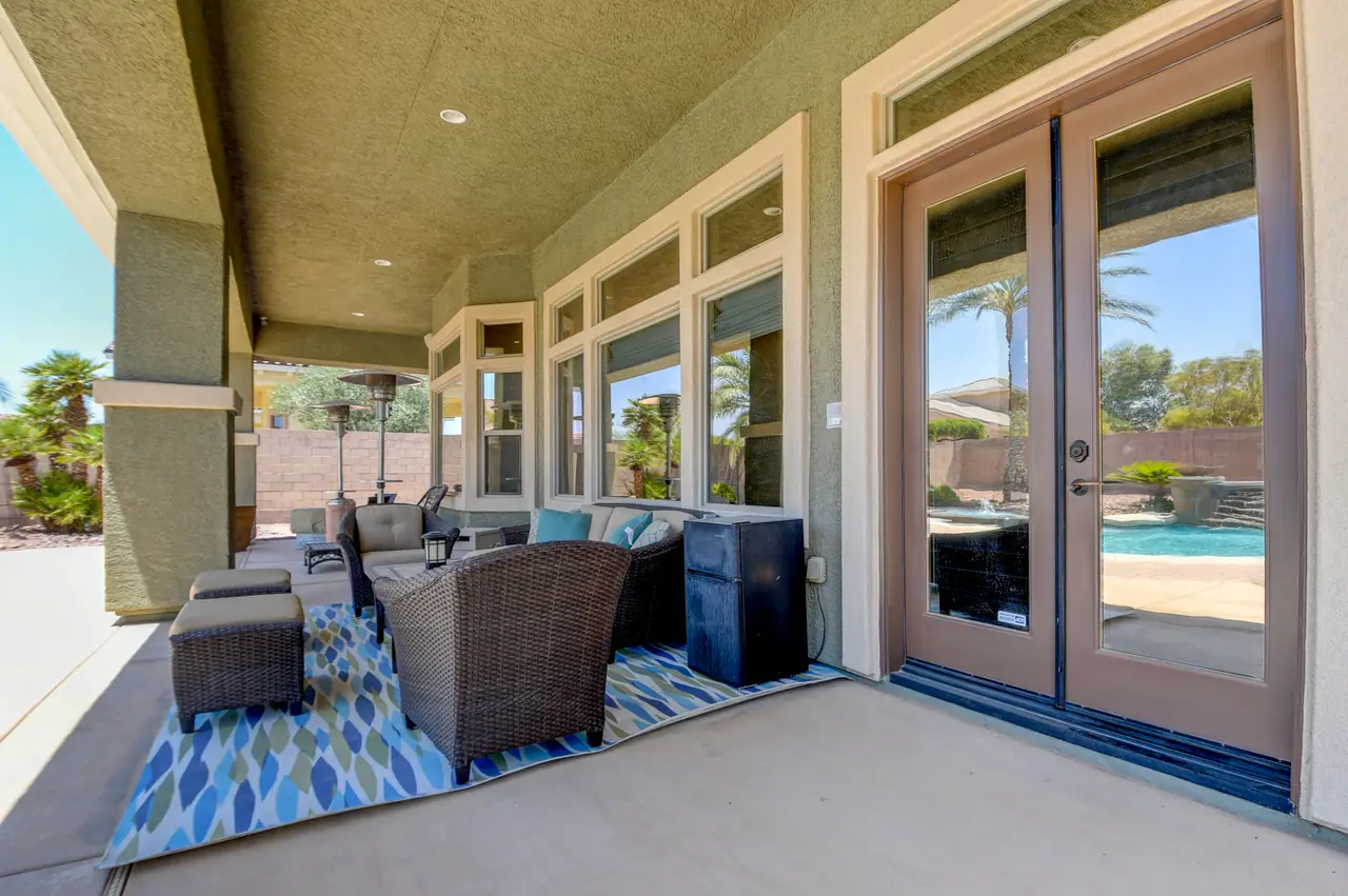 Covered patio with outdoor seating and French doors into the house