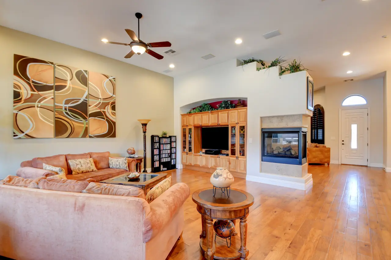 Family room seating area facing the entertainment center and fireplace