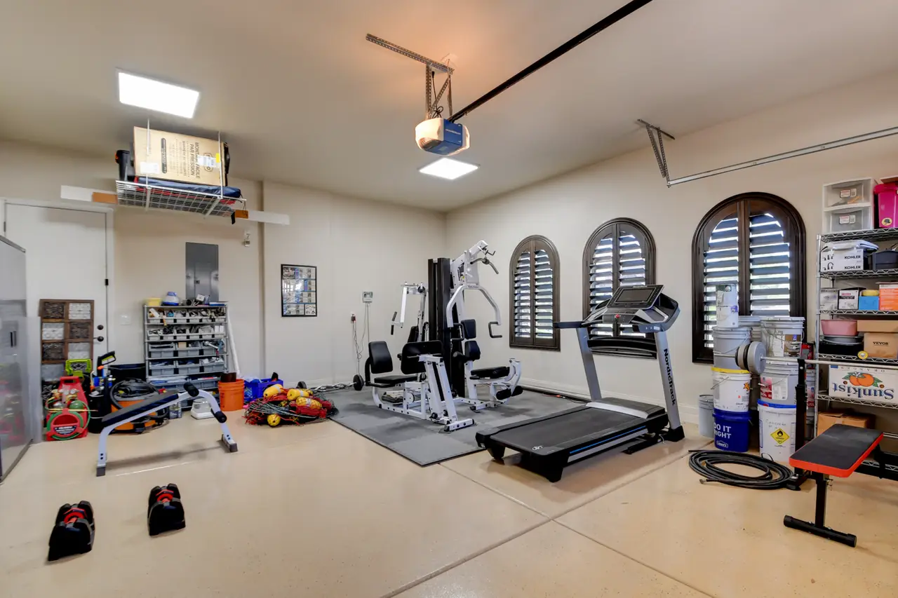 Second garage with epoxy floor set up as a home gym