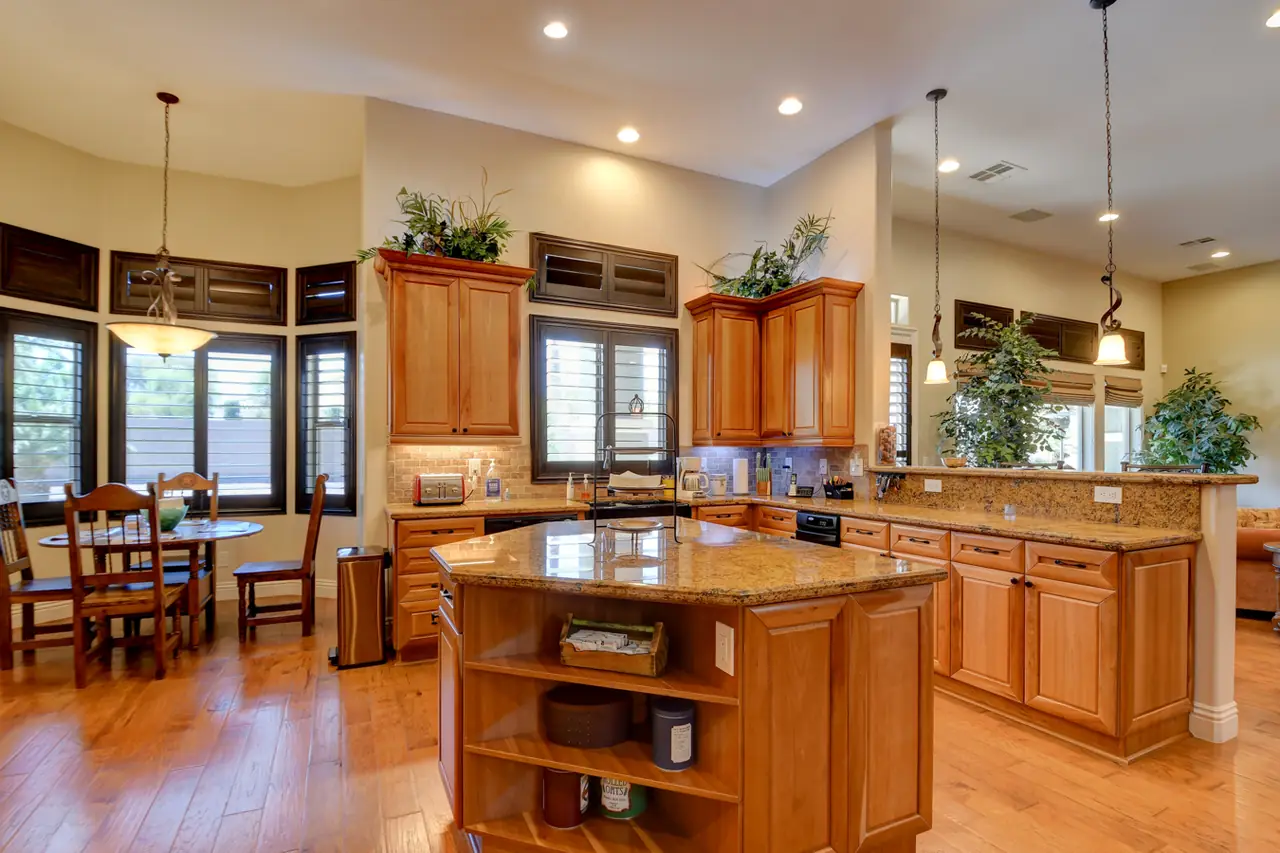 Kitchen island and breakfast area with wood cabinetry