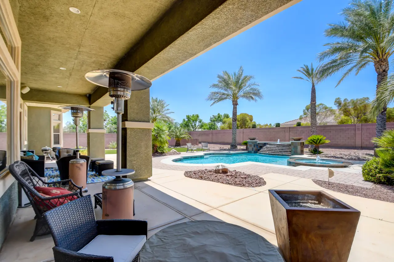 View from the covered patio out to the pool and palms