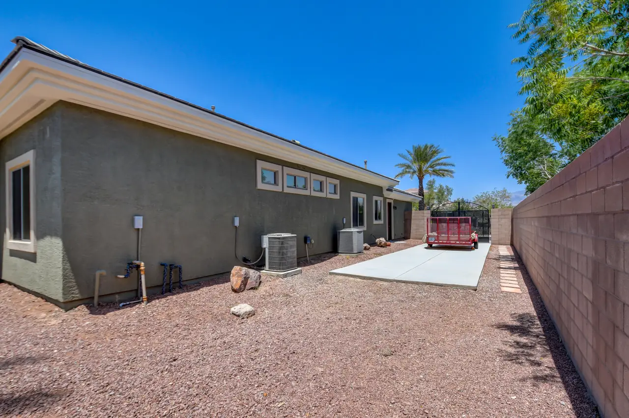 Concrete RV pad along the side of the home behind block walls